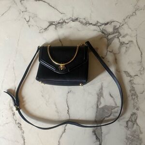 Elegant Black Handbag with Spider emblem and  Gold Accents
